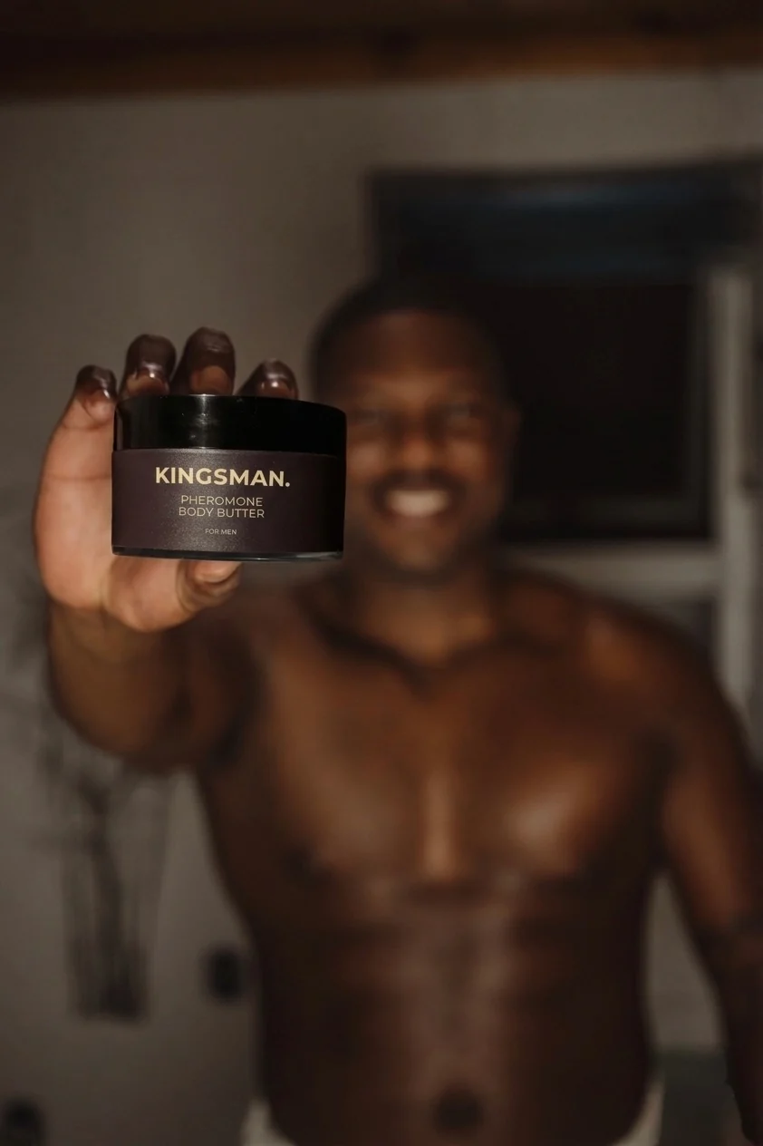 KINGSMAN Pheromone Body Butter held by a customer